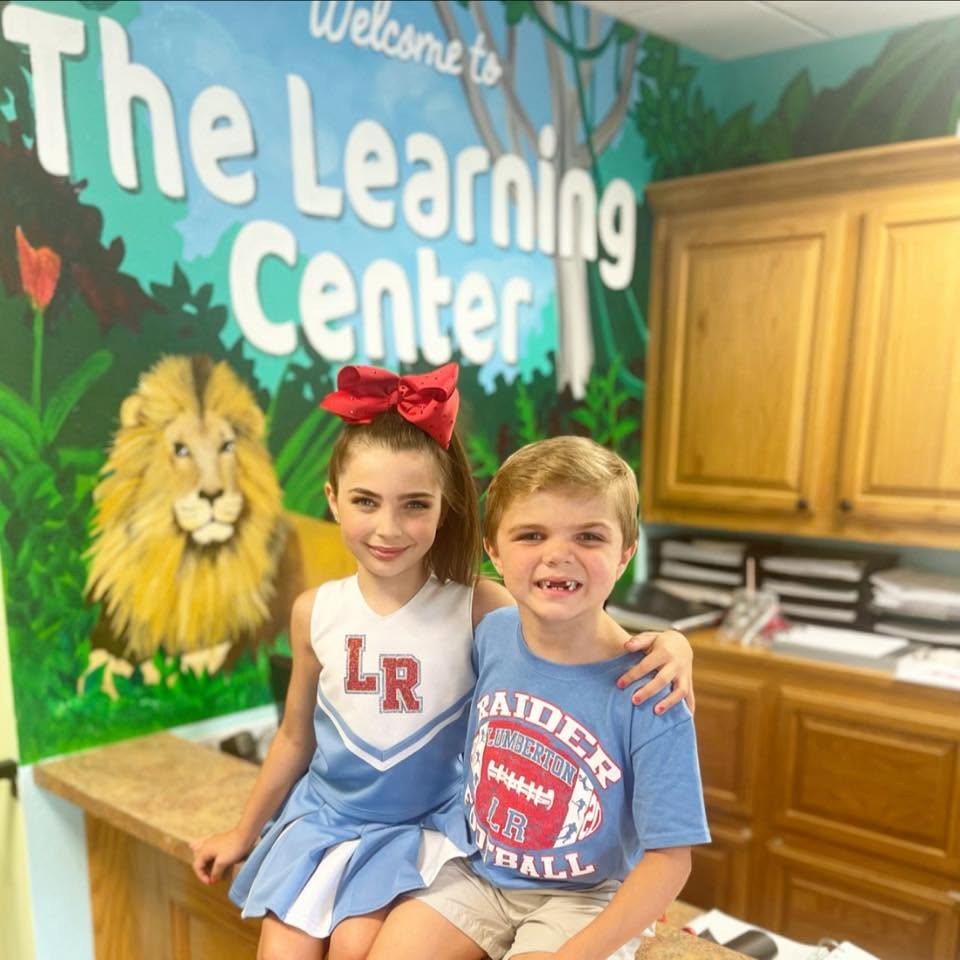 Children smiling inside The Learning Center